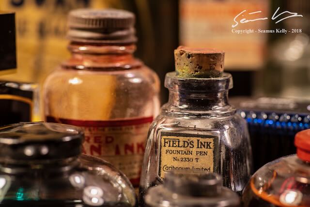 An image of vintage ink bottles with various coloured ink